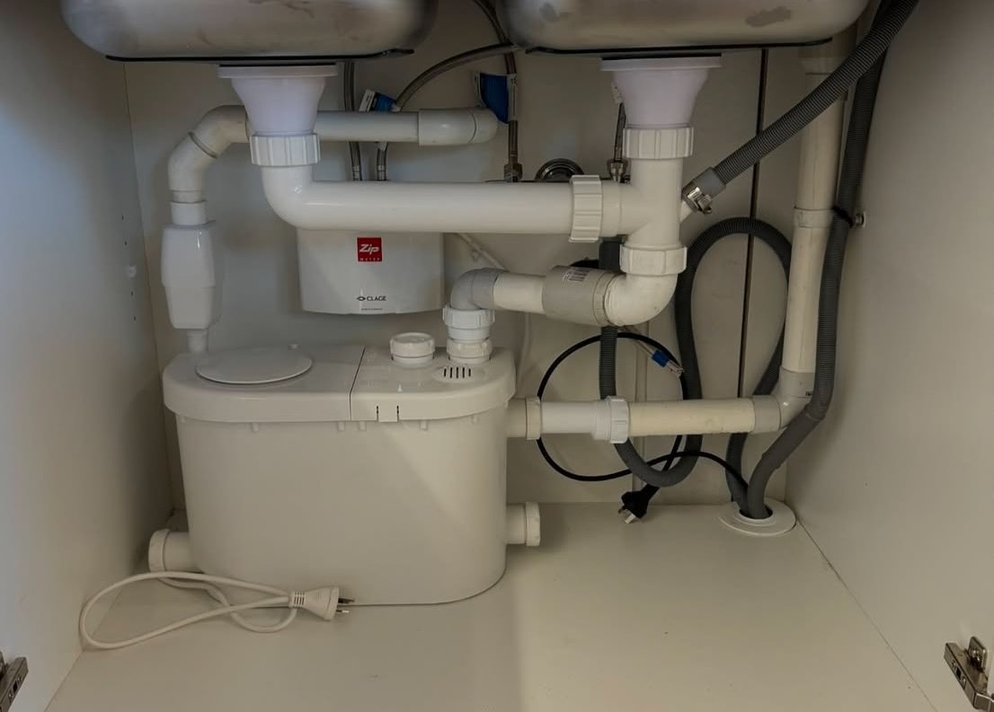 Zip tap and fixture plumbing under a kitchen sink